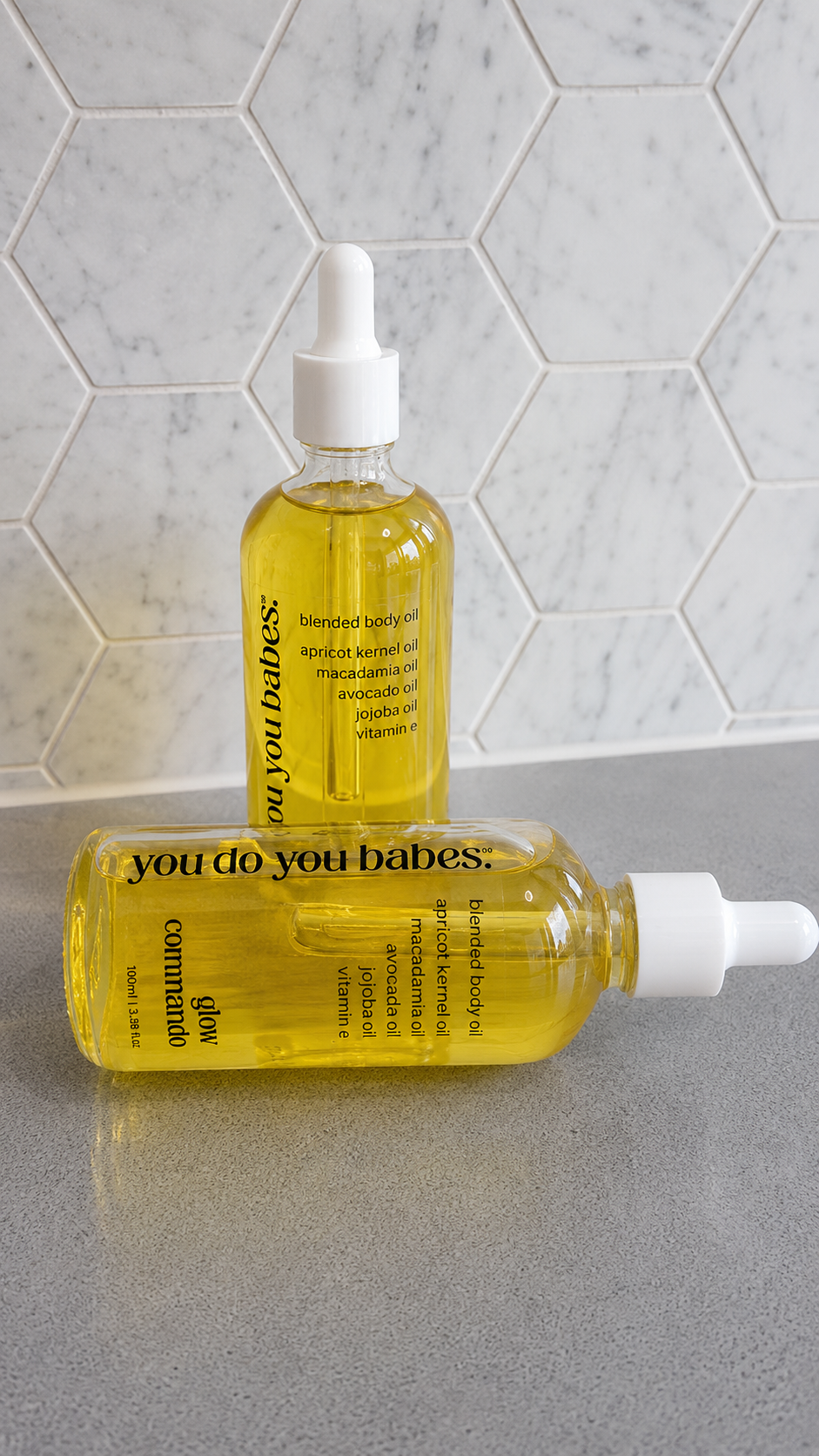 Two bottles of 'you do you babes' skincare product.