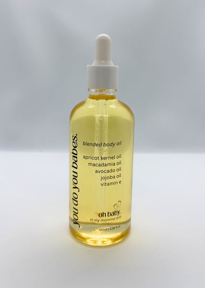 Bottle of blended oh baby body oil with a dropper on a white background