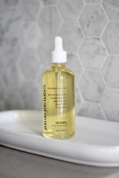 Bottle of 'oh baby!' Body oil with a dropper in a bathroom