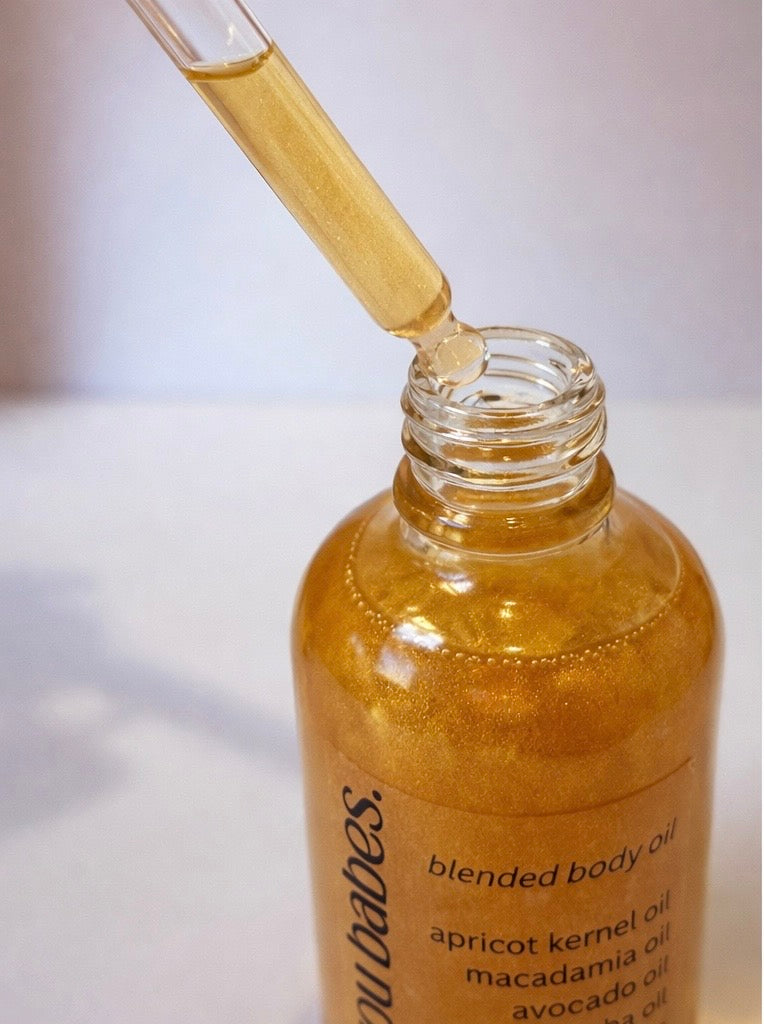 Bottle of shimmer body oil by you do you babes called honey trap 