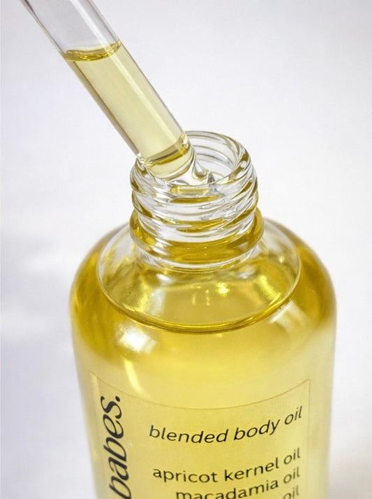 Bottle of blended body oil from you do you babes with a dropper on a white background