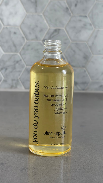 Bottle of blended body oil with a hexagonal tile background